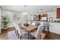 Bright and airy dining room featuring a modern chandelier, wooden table, and an open-concept layout at 557 S Clarkson St, Denver, CO 80209