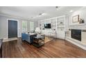 Bright living room featuring hardwood floors, custom built-in shelving, and a cozy fireplace at 557 S Clarkson St, Denver, CO 80209