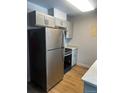 This kitchen features stainless steel appliances and modern lighting fixtures at 6029 S Sycamore St, Littleton, CO 80120