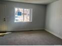 Bright living room featuring neutral walls, carpet, and a large window at 6029 S Sycamore St, Littleton, CO 80120