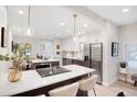 Bright, updated kitchen with a center island, modern appliances, and an adjacent breakfast nook at 7204 W 26Th Ave, Lakewood, CO 80214