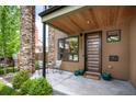 Inviting front porch with stone pillars, a modern door, and a cozy seating area at 2114 Lowell Blvd, Denver, CO 80211