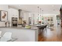 Open-concept kitchen with modern cabinetry, stainless steel appliances, and a large center island at 2114 Lowell Blvd, Denver, CO 80211