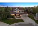 Beautiful two-story home featuring a well-maintained lawn, mature trees, and an attached three-car garage at 3566 E Meadow Creek Pl, Highlands Ranch, CO 80126