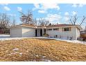 A single story home with a white brick exterior, well-kept front yard, and an attached two-car garage at 2784 E Maplewood Ave, Centennial, CO 80121