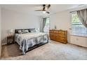 Cozy bedroom with a large bed, carpeted floors, and ample natural light from two windows at 426 N 48Th Ave, Brighton, CO 80601
