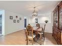 Inviting dining room with hardwood floors, a chandelier, and stylish decor, perfect for Gathering meals at 426 N 48Th Ave, Brighton, CO 80601