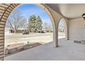Covered brick front porch with view of the street at 2172 S Harlan St, Denver, CO 80227