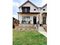 Charming two-story home with white siding, covered porch, and green lawn creates an inviting exterior at 2471 S High St, Denver, CO 80210