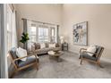 Bright living room featuring a large window, modern furniture, and neutral tones at 16434 Homestead Ct, Parker, CO 80134