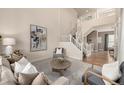 Spacious living room showcasing a staircase, stylish decor, and neutral paint at 16434 Homestead Ct, Parker, CO 80134