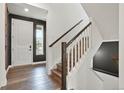 Bright entryway with hardwood floors, a staircase, and a view of the front door and front yard at 26322 E 2Nd Ave, Aurora, CO 80018
