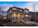 Inviting two-story home with a covered porch, stone detailing, and an attached two-car garage at 26322 E 2Nd Ave, Aurora, CO 80018