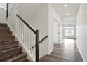 Hallway with hardwood floors and stairs leading up to the second level of the home at 26322 E 2Nd Ave, Aurora, CO 80018