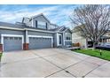 Beautiful two-story home featuring a three-car garage and manicured front lawn at 11575 Wilson Cir, Parker, CO 80134