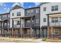 Charming townhomes with two-tone exteriors, inviting balconies, and well-maintained landscaping at 6824 Huddersfield Ln, Castle Pines, CO 80108