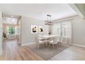 Elegant dining room featuring modern décor, a large window, and stylish chandelier at 9015 W Tanforan Dr, Littleton, CO 80123