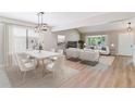 Bright and airy living room with modern furniture and a dining area with stylish chandelier at 9015 W Tanforan Dr, Littleton, CO 80123