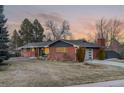 Ranch house with a modern exterior and attached garage at 5965 W Quarles Dr, Littleton, CO 80128