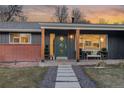 Modern front porch with green door and stone walkway at 5965 W Quarles Dr, Littleton, CO 80128