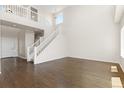 Open foyer featuring hardwood floors, a staircase with white railings, and lots of natural light at 2509 S Bahama Way, Aurora, CO 80013