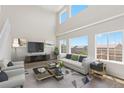 Bright living room boasting soaring ceilings, lots of natural light, neutral color palette, and modern furniture at 2509 S Bahama Way, Aurora, CO 80013