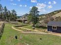 Expansive backyard featuring a lush lawn, mature trees and a separate garage structure at 5384 Olde Stage Rd, Boulder, CO 80302