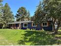 View of the home's exterior, showcasing wood shutters and lovely landscaping that enhances its curb appeal at 5384 Olde Stage Rd, Boulder, CO 80302