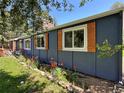 Detailed view of the home's exterior, showing window shutters and the beautiful flower bed at 5384 Olde Stage Rd, Boulder, CO 80302