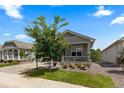 Inviting home with well-manicured lawn, flower beds, and a cozy front porch at 15802 Xanthia Way, Thornton, CO 80602