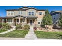 Inviting two-story townhome with well-manicured lawn and covered front entrance at 3075 Distant Rock Ave, Castle Rock, CO 80109