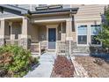 Inviting covered porch features stone accents, and a cozy seating area at 3075 Distant Rock Ave, Castle Rock, CO 80109