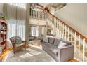 Open concept living room features a staircase, hardwood floors, and plenty of natural light at 6462 Freeport Dr, Highlands Ranch, CO 80130