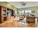 Spacious living room with hardwood floors, a ceiling fan, and lots of natural light at 16399 Somerset Dr, Broomfield, CO 80023