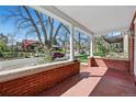 Charming front porch with brick base and columns, perfect for relaxing and enjoying the neighborhood view at 2772 Julian St, Denver, CO 80211