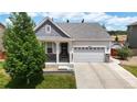Inviting single-Gathering home with a two-car garage, a covered front porch, and a beautifully landscaped yard at 3885 Sandoval St, Brighton, CO 80601