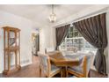 Bright dining room with a window, a chandelier, and hardwood floors at 6052 Jay St, Arvada, CO 80003