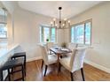 Cozy dining area featuring a stylish chandelier and a bay window for ample natural light at 3578 Ivanhoe St, Denver, CO 80207