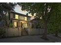 Charming home exterior with decorative wrought iron fence, mature trees, and classic architecture at dusk at 734 N Downing St, Denver, CO 80218