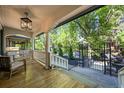 Inviting front porch with wood floors, white railings, decorative columns, and stylish overhead lighting fixture at 734 N Downing St, Denver, CO 80218