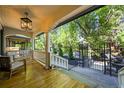 Inviting covered porch with wooden floors, white railings and columns, and outdoor seating at 734 N Downing St, Denver, CO 80218