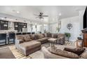 Spacious living room area with gray walls, wood flooring, and a plush sectional sofa at 1222 S County Road 185, Byers, CO 80103