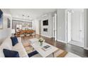 Bright living room featuring hardwood floors, a fireplace, an open floorplan, and modern decor with gray accents at 336 E 1St Ave # 207, Denver, CO 80203