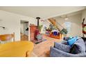 Bright living area with a wood-burning stove, hardwood floors, and staircase at 810 Miner St, Idaho Springs, CO 80452