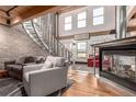 Bright living room featuring a fireplace, spiral staircase, and wood floors at 1745 Wazee St # 5E, Denver, CO 80202