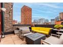 Modern rooftop terrace with comfortable seating and city views at 1745 Wazee St # 5E, Denver, CO 80202