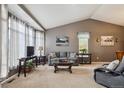 Bright living room featuring vaulted ceilings, large bay windows, and comfortable furnishings at 12705 Home Farm Dr, Westminster, CO 80234