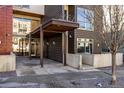 Building entrance with a covered walkway, modern design and access features at 2650 Front View # 205, Denver, CO 80211