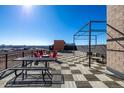 Expansive rooftop deck featuring picnic tables and lounge seating with city views at 2650 Front View # 205, Denver, CO 80211