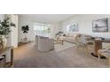 Bright living room featuring modern furniture, neutral tones, and access to a private balcony at 725 S Alton Way # 7D, Denver, CO 80247